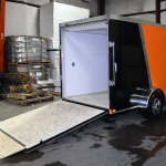 open back of orange and black single axle trailer