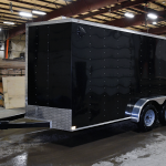 side of black tandem axle trailer