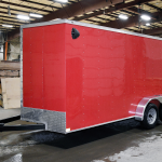 side of red tandem axle trailer