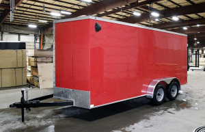 side of red tandem axle trailer